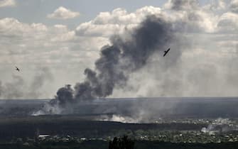 TOPSHOT - Smoke and dirt rise from shelling in the city of Severodonetsk during fight between Ukrainian and Russian troops in the eastern Ukrainian region of Donbas on June 7, 2022. (Photo by ARIS MESSINIS / AFP)