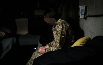A Ukrainian soldier, mother of a five-year-old boy, uses a smartphone near Kramatorsk, eastern Ukraine on May 13, 2022. - More than six million refugees have fled Ukraine since Russia's invasion began on February 24, 2022, the UN refugee agency says. A total of 6,029,705 people had fled Ukraine as of May 11, with Poland hosting the largest number. Women and children represent 90 percent of the refugees. (Photo by Yasuyoshi CHIBA / AFP) (Photo by YASUYOSHI CHIBA/AFP via Getty Images)