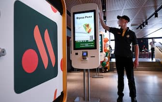 An employee cleans a self-ordering machine at the Russian version of a former McDonald's restaurant before the opening ceremony, in Moscow on June 12, 2022. (Photo by Kirill KUDRYAVTSEV / AFP) (Photo by KIRILL KUDRYAVTSEV / AFP via Getty Images)