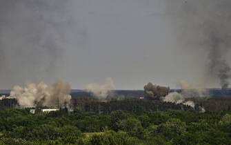 Smoke and dirt rise in the city of Severodonetsk during heavy fightings between Ukrainian and Russian troops at eastern Ukrainian region of Donbas on May 30, 2022, on the 96th day of the Russian invasion of Ukraine. - EU leaders will try to overcome Hungary's rejection of a Russian oil embargo on May 30, 2022 as part of a further tightening of sanctions against Moscow, whose forces are advancing in eastern Ukraine, with fighting in the heart of the key city of Severodonetsk. (Photo by ARIS MESSINIS / AFP) (Photo by ARIS MESSINIS/AFP via Getty Images)