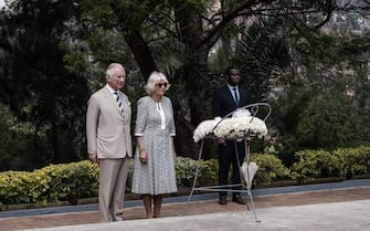 Britain's Prince Charles, Prince of Wales, and Britain's Camilla, Duchess of Cornwall pause in front of a flower wreath at the Kigali Genocide Memorial, Kigali, Rwanda on June 22, 2022 during a visit. - Britain's Prince Charles will take part in the 26th Commonwealth Heads of Government Meeting held in Kigali, Rwanda from the 20 june until the 25 June 2022. (Photo by Simon WOHLFAHRT / AFP) (Photo by SIMON WOHLFAHRT/AFP via Getty Images)