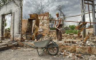Anatolii Navozenko (61), a local farmer, cleans the debris of his house in Novoselivka village, Chernihiv region, Ukraine, 23 June 2022. Anatolii's and his family homes were destroyed in a Russian shelling in March 2022. Now his mother Natalia (82) temporarily lives in the greenhouse. On 24 February Russian troops entered Ukrainian territory starting a conflict that has provoked destruction and a humanitarian crisis. ANSA/OLEG PETRASYUK  ATTENTION: This Image is part of a PHOTO SET