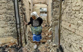 Hanna walks inside remains of her house, destroyed in a Russian shelling in Chernihiv city, Ukraine, 23 June 2022. On 24 February Russian troops entered Ukrainian territory starting a conflict that has provoked destruction and a humanitarian crisis.  ANSA/OLEG PETRASYUK