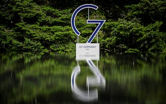 epa10036018 The logo of the G7 Summit is reflected in a pond at Elmau Castle in Kruen, Germany, 27 June 2022. Germany is hosting the G7 summit at Elmau Castle near Garmisch-Partenkirchen from 26 to 28 June 2022.  EPA/CHRISTIAN BRUNA