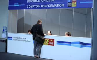 MADRID, SPAIN - JUNE 28: A participant receives help from an information desk ahead of NATO Summit in Madrid, Spain on June 28, 2022. (Photo by Dursun Aydemir/Anadolu Agency via Getty Images)