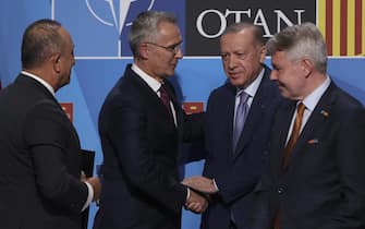 epa10039545 NATO Secretary General Jens Stolteneberg (2L); shakes hands with the Turkish president, Recep Tayyip Erdogan (2d), after the signing of an agreement to unblock the Turkish veto to the accession of Finland and Sweden to NATO, in Madrid, Spain, 28 June 2022.  EPA/Kiko Huesca