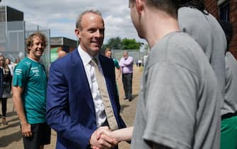 EMBARGOED TO 2200 THURSDAY MAY 12 Justice Secretary Dominic Raab (center) and Formula 1 driver Sebastian Vettel meeting young offenders during their visit to HMP Feltham, London to launch a new mechanics workshop for offenders aged 18 to 21 to help them gain formal qualifications.  Picture date: Thursday May 12, 2022.
