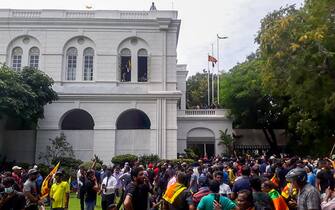 1241791162 Protestors gather inside the compound of Sri Lanka's Presidential Palace in Colombo on July 9, 2022. - Sri Lanka's beleaguered President Gotabaya Rajapaksa fled his official residence in Colombo, a top defence source told AFP, before protesters gathered to demand his resignation stormed the compound. (Photo by AFP) (Photo by -/AFP via Getty Images)