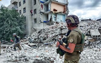 A handout photo made available by the National police press service on 10 July 2022 shows Ukrainian rescuers clean the debris of a residential building after shelling in Chasiv Yar, Ukraine, 10 July 2022. At least 15 people were killed and five injured as a result of the Russian rocket fire on 09 July, the State Emergency Services said. Russian troops on 24 February entered Ukrainian territory, starting a conflict that has provoked destruction and a humanitarian crisis. ANSA/National police press service / HANDOUT  HANDOUT EDITORIAL USE ONLY/NO SALES