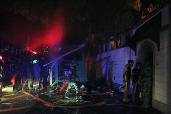 1241805353 COLOMBO, SRI LANKA â JULY 09: Firefighters in action at the private residence of Prime Minister Private Residence after protestors set it on fire in Colombo Sri Lanka, July 09, 2022. Months into the countryâs worst-ever economic crisis, thousands of protesters in Sri Lanka on Saturday stormed the presidentâs official residence and demanded his immediate resignation, local media reported. Holding Sri Lankan flags and helmets, some protesters broke through police barricades and entered President Gotabaya Rajapaksaâs residence in the capital Colombo, leading law enforcement to fire in the air to disperse them, according to video from local TV news channel NewsFirst. Local media claimed that Rajapaksa left the residence and was taken to a safe place. TV footage shows some of these protestors bursting through the gates of the presidential secretariat on the seafront, which has been the site of a sit-in protest for months. Prime Minister Ranil Wickremesinghe called an emergency meeting of political party leaders amid growing anger over the governmentâs handling of the economic crisis. (Photo by M.A. Pushpa Kumara/Anadolu Agency via Getty Images)