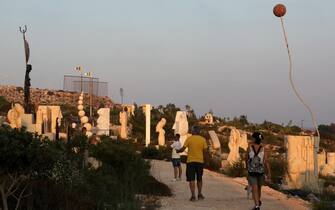 epa08624922 Tourists walk in the Sculpture Park of Ayia Napa, Cyprus, 25 August 2020. The park was created with 252 sculpture works from 145 different artists around the world and was established as a unique attraction of interest.  EPA/KATIA CHRISTODOULOU