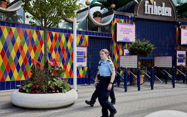 Police walk outside the closed Tivoli Friheden amusement park, in Aarhus, western Denmark, after a 14-year-old girl was killed and a 13-year-old boy injured in a roller coaster accident, on July 14, 2022. - The accident occurred shortly before 1:00 p.m. (11:00 GMT) when a trolley came off the "Cobra" attraction, the director of the Tivoli Friheden amusement park said. - Denmark OUT (Photo by Mikkel Berg Pedersen / Ritzau Scanpix / AFP) / Denmark OUT (Photo by MIKKEL BERG PEDERSEN/Ritzau Scanpix/AFP via Getty Images)