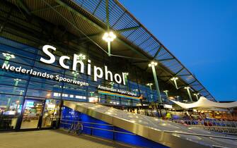 The entrance of Amsterdam Airport Schiphol in the evening.  Schiphol is located 9 kilometers southwest of Amsterdam.