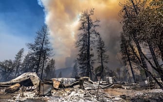 Destroyed property is left in its wake as the Oak Fire chews through the forest near Midpines, northeast of Mariposa, California, on July 23, 2022. - The fire is burning west of Yosemite National Park where the Washburn Fire has threatened the giant sequoia trees of the Mariposa Grove.  (Photo by DAVID MCNEW / AFP) (Photo by DAVID MCNEW / AFP via Getty Images)
