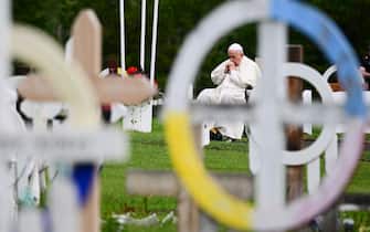 Pope Francis visits the Ermineskin Cree Nation Cemetery in Maskwacis, south of Edmonton, western Canada, on July 25, 2022. - Pope Francis visits Canada for a chance to personally apologise to Indigenous survivors of abuse committed over a span of decades at residential schools run by the Catholic Church. (Photo by Vincenzo PINTO / AFP) (Photo by VINCENZO PINTO/AFP via Getty Images)