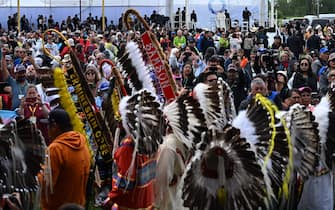 Members of the Indigenous community look on as Pope Francis arrives at Muskwa Park in Maskwacis, Alberta, Canada, on July 25, 2022. - Pope Francis will make a historic personal apology Monday to Indigenous survivors of child abuse committed over decades at Catholic-run institutions in Canada, at the start of a week-long visit he has described as a "penitential journey." (Photo by Patrick T. FALLON / AFP) (Photo by PATRICK T. FALLON/AFP via Getty Images)