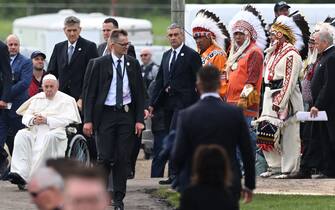 Pope Francis (L) arrives to speak to Indigenous community members at Muskwa Park in Maskwacis, Alberta, Canada, on July 25, 2022. - Pope Francis will make a historic personal apology Monday to Indigenous survivors of child abuse committed over decades at Catholic-run institutions in Canada, at the start of a week-long visit he has described as a "penitential journey." (Photo by Patrick T. FALLON / AFP) (Photo by PATRICK T. FALLON/AFP via Getty Images)