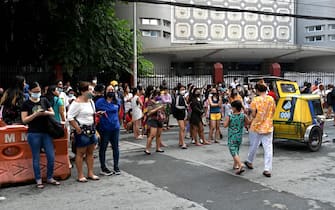 Residents evacuate their building after a 7.1 magnitude earthquake, some 300 kilometers away, was felt in Manila on July 27, 2022. (Photo by JAM STA ROSA / AFP) (Photo by JAM STA ROSA/AFP via Getty Images)