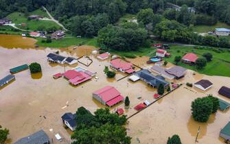 Aerial view of homes submerged under flood waters from the North Fork of the Kentucky River in Jackson, Kentucky, on July 28, 2022. - At least three people have died after torrential rains caused massive flooding in eastern Kentucky, leaving a number of people stranded on rooftops and in trees, the governor of the southeastern US state said Thursday. (Photo by LEANDRO LOZADA / AFP) (Photo by LEANDRO LOZADA/AFP via Getty Images)