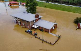 Aerial view of homes submerged under flood waters from the North Fork of the Kentucky River in Jackson, Kentucky, on July 28, 2022. - Flash flooding caused by torrential rains has killed at least eight people in eastern Kentucky and left some residents stranded on rooftops and in trees, the governor of the south-central US state said Thursday. (Photo by LEANDRO LOZADA / AFP) (Photo by LEANDRO LOZADA/AFP via Getty Images)