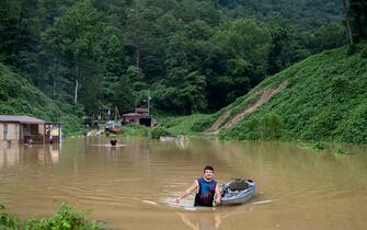JACKSON, KY - JULY 28: Lewis Ritchie, pulls a kayak through the water after delivering groceries to his father-in-law on July 28, 2022 outside Jackson, Kentucky. Storms that dropped as much as 12 inches of rain in some parts of Eastern Kentucky have caused devastating floods in some areas and have claimed at least eight lives. (Photo by Michael Swensen/Getty Images)