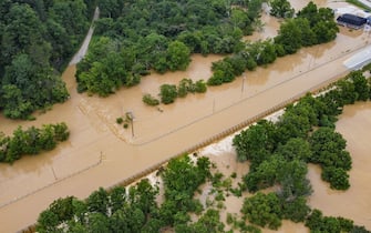 Aerial view of a road and houses submerged under flood waters from the North Fork of the Kentucky River in Jackson, Kentucky, on July 28, 2022. - At least eight people have died after torrential rains caused massive flooding in eastern Kentucky, leaving a number of people stranded on rooftops and in trees, the governor of the southeastern US state said Thursday. (Photo by LEANDRO LOZADA / AFP) (Photo by LEANDRO LOZADA/AFP via Getty Images)