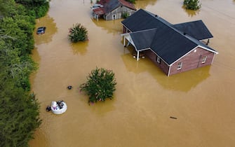 Aerial view of homes submerged under flood waters from the North Fork of the Kentucky River in Jackson, Kentucky, on July 28, 2022. - At least eight people have died after torrential rains caused massive flooding in eastern Kentucky, leaving a number of people stranded on rooftops and in trees, the governor of the southeastern US state said Thursday. (Photo by LEANDRO LOZADA / AFP) (Photo by LEANDRO LOZADA/AFP via Getty Images)