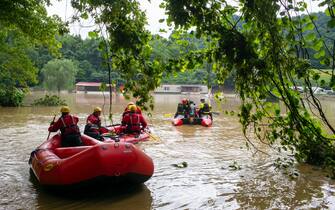 LOST CREEK, KY - JULY 29:  Lexington Firefighters' swift water rescue teams head up overflowed Troublesome Creek to rescue people that have been stranded since Wednesday night in Lost Creek, Kentucky on July 29, 2022. At least 16 people have been killed and hundreds had to be rescued amid flooding from heavy rainfall.  (Photo by Michael Swensen/Getty Images)