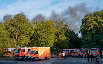 04 August 2022, Berlin: Fire engines stand on Kronprinzessinnenweg in Berlin. A fire broke out in Berlin's Grunewald forest after an accidental explosion at the blasting site there on Thursday morning, setting fire to the adjacent forest. Photo: Christophe Gateau/dpa (Photo by Christophe Gateau/picture alliance via Getty Images)