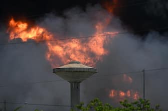 View of an oil tank on fire in Matanzas, Cuba, on August 6, 2022. - The fire caused by lightning on Friday in a fuel depot in Matanzas, in western Cuba, spread to a second tank at dawn this Saturday and caused 49 injuries, official sources reported. (Photo by YAMIL LAGE / AFP) (Photo by YAMIL LAGE/AFP via Getty Images)