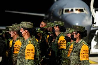 Members of the Mexican army arrive to the Juan Gualberto Gomez International Airport in Matanzas Province, Cuba, August 6, 2022. - A Mexican Air Force plane arrived the night of August 6 at Varadero airport, in western Cuba, with 60 military personnel and 22 technical specialists from Petroleos Mexicanos to help extinguish a large fire in two fuel tanks, which has left one dead and 121 injured, 36 of whom are still hospitalized. Cuba asked for help on August 6 to contain a massive fire at a fuel depot that has left at least one person dead, 121 people injured and 17 firefighters missing. (Photo by YAMIL LAGE / AFP) (Photo by YAMIL LAGE/AFP via Getty Images)