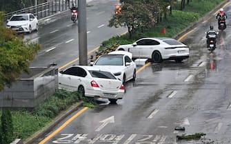 Cars damaged by flood water are seen on the street after heavy rainfall at Gangnam district in Seoul on August 9, 2022. (Photo by Jung Yeon-je / AFP) (Photo by JUNG YEON-JE/AFP via Getty Images)