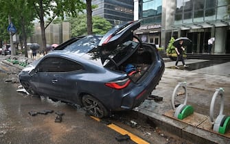 A car damaged by flood water is seen on the street after heavy rainfall at Gangnam district in Seoul on August 9, 2022. (Photo by Jung Yeon-je / AFP) (Photo by JUNG YEON-JE / AFP via Getty Images)