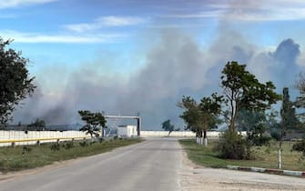 epa10112854 A handout picture made available by the Department of Information and Press Service of the Head of the Republic of Crimea shows smoke rising after detonations of air munisions at the Saki airfield near the Novofedorovka settlement, Crimea, 09 August 2022. Violation of the fire safety rules is being probed as the main cause of the explosion of ammunition at the Saki airfield in Crimea; there is no sign that they were blown up intentionally, a source at the Russian Defense Ministry said.  EPA/Press Office of Head of Crimea HANDOUT MANDATORY CREDIT HANDOUT EDITORIAL USE ONLY/NO SALES