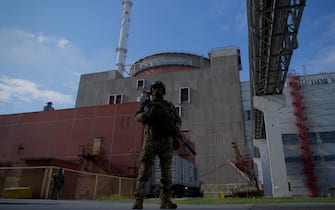 A Russian serviceman stands guard the territory outside the second reactor of the Zaporizhzhia Nuclear Power Station in Energodar on May 1, 2022. - The Zaporizhzhia Nuclear Power Station in southeastern Ukraine is the largest nuclear power plant in Europe and among the 10 largest in the world. 
 *EDITOR'S NOTE: This picture was taken during a media trip organised by the Russian army.* (Photo by Andrey BORODULIN / AFP) (Photo by ANDREY BORODULIN/AFP via Getty Images)