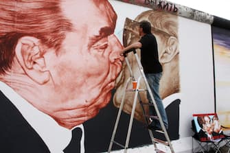 Vrubel, Dimitry - Painter, Artist, Russia - During the restauration of the painting "Brotherly Kiss (Bruderkuss) at the East Side Gallery in Friedrichshain    (Photo by Anke Thomass/ullstein bild via Getty Images)