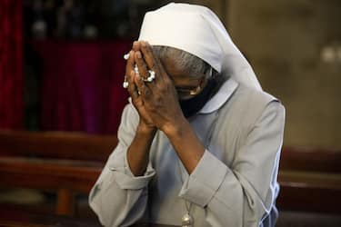 KHARTOUM, SUDAN - DECEMBER 25: A nun prays as determined number of worshipers are being allowed to attend Christmas Eve Mass amid the coronavirus (Covid- 19) pandemic at St. Matthew Cathedral in Khartoum, Sudan on December 25, 2020. (Photo by Mahmoud Hjaj/Anadolu Agency via Getty Images)