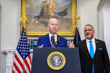 epa10136889 US President Joe Biden gives remarks as Secretary of Education Miguel Cardona looks on after Biden announced a federal student loan relief plan that includes forgiving up to $20,000 for some borrowers and extending the payment freeze in the Roosevelt Room at the White House in Washington, DC, USA, on 24 August 2022. Borrowers who make less $125,000 are eligible for $10,000 in loan forgiveness while Pell Grant borrowers are eligible for $20,000 debt cancellation.  EPA/BONNIE CASH / POOL