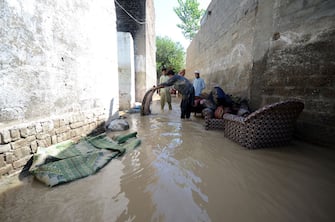 CHARSADDA, PAKISTAN - AUGUST 28: People are seen trying to survive at a flooded area in Charsadda, Khyber Pakhtunkhwa province, Pakistan on August 28, 2022. Flash floods triggered by destructive monsoon rains have killed more than 1,000 people and injured thousands more since June. Pakistan is appealing for further international assistance while the government has declared an emergency to deal with the serious climate catastrophe that devastated the country. (Photo by Hussain Ali/Anadolu Agency via Getty Images)
