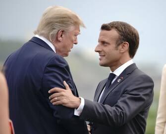 24 August 2019, France (France), Biarritz: Emmanuel Macron (r), President of France, speaks with Donald Trump, President of the USA, at the welcome at the lighthouse. France holds the rotating presidency of the G7 summit of the major industrialised countries. The G7 summit will take place from 24 to 26 August in Biarritz. Photo: Michael Kappeler/dpa (Photo by Michael Kappeler/picture alliance via Getty Images)