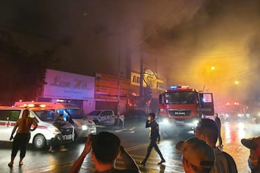 This picture taken on September 6, 2022 and released on September 7 by the Vietnam News Agency shows firefighters at the scene of a deadly fire that engulfed a karaoke bar in Binh Duong province, north of Ho Chi Minh City. - A fire tore through a karaoke bar in Vietnam killing 12 people and leaving 11 injured, a local official said September 7. (Photo by Vietnam News Agency / AFP) (Photo by STR/Vietnam News Agency/AFP via Getty Images)