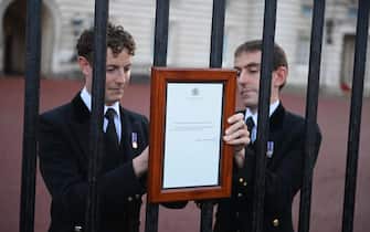 epaselect epa10170957 Members of the royal household post the official announcement of the death of Britain's Queen Elizabeth II on the gates of the Buckingham Palace in London, Britain, 08 September 2022. According to a statement issued by Buckingham Palace on 08 September 2022, Britain's Queen Elizabeth II has died at her Scottish estate, Balmoral Castle, on 08 September 2022. The 96-year-old Queen was the longest-reigning monarch in British history.  EPA/NEIL HALL
