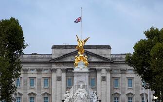 TOPSHOT - The Union flag flies at half-mast atop Buckingham Palace, beyond the Queen Victoria Memorial statue, in London on September 9, 2022, a day after Queen Elizabeth II died at the age of 96. - Queen Elizabeth II, the longest-serving monarch in British history and an icon instantly recognisable to billions of people around the world, died at her Scottish Highland retreat on September 8. (Photo by Niklas HALLE'N / AFP) (Photo by NIKLAS HALLE'N/AFP via Getty Images)