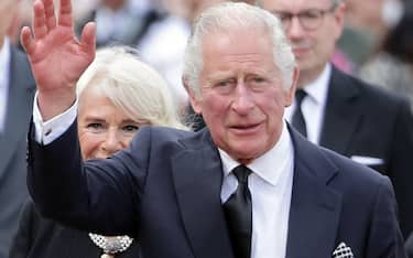 LONDON, ENGLAND - SEPTEMBER 09:  King Charles III waves to the public after viewing floral tributes to the late Queen Elizabeth II outside Buckingham Palace on September 09, 2022 in London, United Kingdom. Elizabeth Alexandra Mary Windsor was born in Bruton Street, Mayfair, London on 21 April 1926. She married Prince Philip in 1947 and acceded the throne of the United Kingdom and Commonwealth on 6 February 1952 after the death of her Father, King George VI. Queen Elizabeth II died at Balmoral Castle in Scotland on September 8, 2022, and is succeeded by her eldest son, King Charles III. (Photo by Chris Jackson/Getty Images)