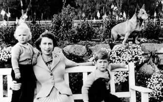 File photo dated 29/04/53 of (left to right) the Princess Royal (then Princess Anne), Queen Elizabeth II and the Duke of York (then Prince Andrew) at Balmoral, Scotland, on a garden bench with the Queen's corgi, Sue, in the background.