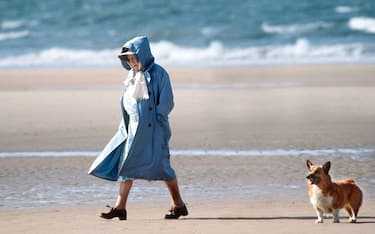 UNITED KINGDOM - JULY 28:  The Queen Mother Walking With One Of Her Friends And Her Corgi On The Beach In Norfolk.  (Photo by Tim Graham Photo Library via Getty Images)
