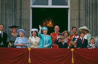 Queen Elizabeth II and Prince William waving from the balcony of Buckingham Palace during the Trooping The Colour Ceremony, The Queen's Official Birthday. (L To R) Prince Edward, Duchess Of York, Queen Mother, Princess Margaret, Queen Elizabeth II, Prince Philip, Prince William, The Grand Duchess Josephine Charlotte Of Luxembourg, Prince Harry, Prince Charles, Lord Frederick Windsor, Princess Diana, Lady Rose Windsor, 16th June 1990. (Photo by Georges De Keerle/Getty Images)