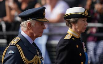 King Charles III and the Princess Royal walk behind the coffin of Queen Elizabeth II, draped in the Royal Standard with the Imperial State Crown placed on top,as its carried on a horse-drawn gun carriage of the King's Troop Royal Horse Artillery, during the ceremonial procession from Buckingham Palace to Westminster Hall, London, where it will lie in state ahead of her funeral on Monday. Picture date: Wednesday September 14, 2022.