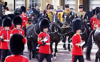 The coffin of Queen Elizabeth II, draped in the Royal Standard with the Imperial State Crown placed on top, is carried on a horse-drawn gun carriage of the King's Troop Royal Horse Artillery, during the ceremonial procession from Buckingham Palace to Westminster Hall, London, where it will lie in state ahead of her funeral on Monday. Picture date: Wednesday September 14, 2022.