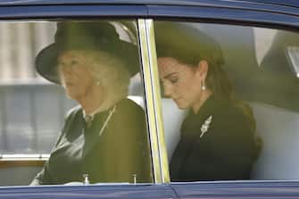epa10183618 Britain's Camilla, Queen Consort (L) and Catherine, Princess of Wales, in a car, follow the procession of the coffin containing the body of Britain's Queen Elizabeth II as it is transported on a gun carriage from Buckingham Palace to Westminster Hall followed by members of the royal family in London, Britain, 14 September 2022. After a short service, the Queen s lying in state will begin, lasting for four days and ending on the morning of the state funeral on the 19 September.  EPA/TOLGA AKMEN